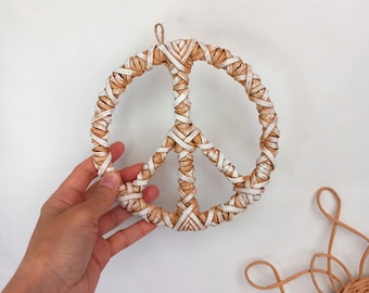 Adorno de pared de ratán con el símbolo de la paz para una decoración de pared de estilo bohemio.