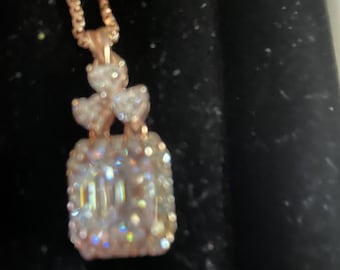 Emerald cut diamond necklace with 3 hearts.