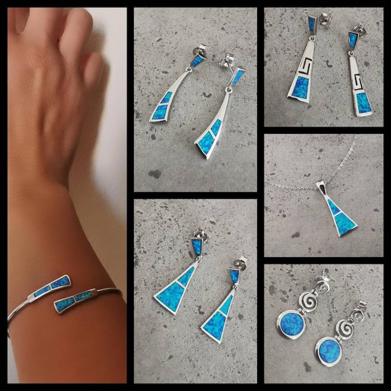 May include: A set of silver jewelry featuring blue opal stones. The set includes a pair of dangle earrings, a pair of stud earrings, a pendant necklace, and a bracelet. The jewelry is made in a geometric design with a triangular shape.
