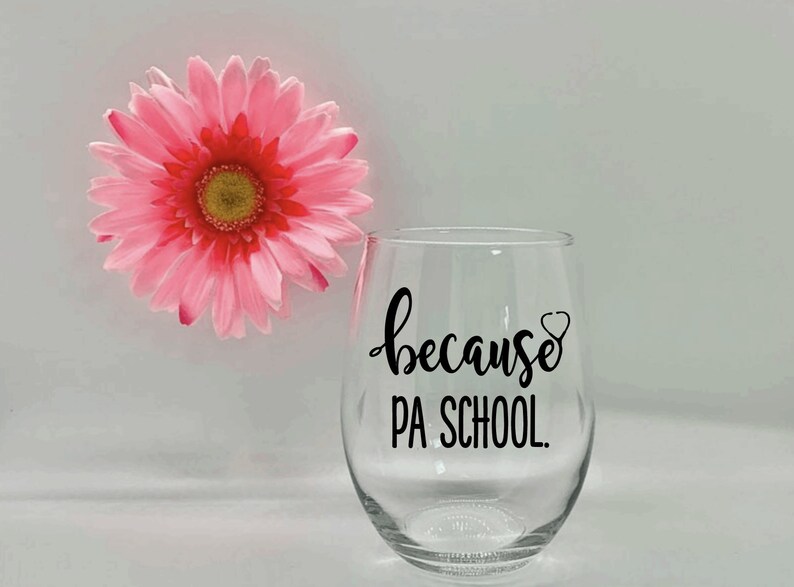 May include: A clear glass wine glass with a black vinyl decal that reads "because PA SCHOOL."  The decal also includes a small stethoscope graphic.