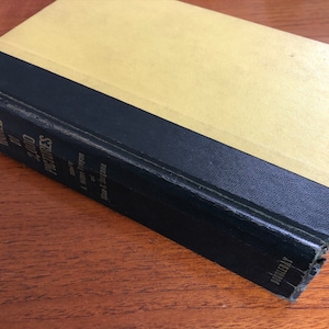 May include: A yellow and black hardback book titled "Around the World in 2,000 Pictures" by a team of experts, edited by F.  M.  D'Evelyn, published by Doubleday.