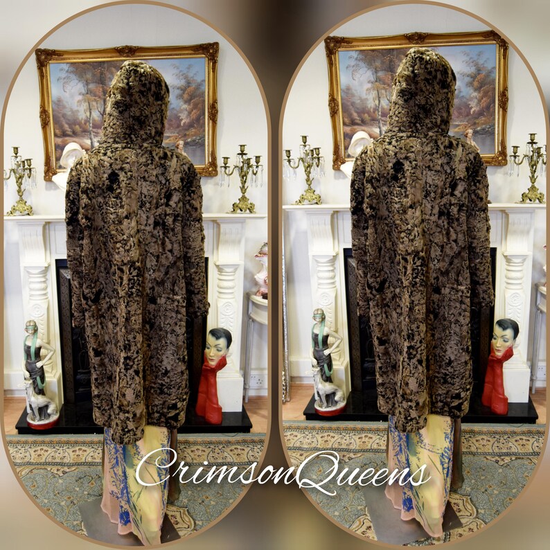 May include: A hooded, long coat with a textured, dark brown and black pattern. The coat is displayed on a mannequin. The bottom of the coat reveals a colorful, patterned fabric. The text "Crimson Queens" is visible at the bottom.