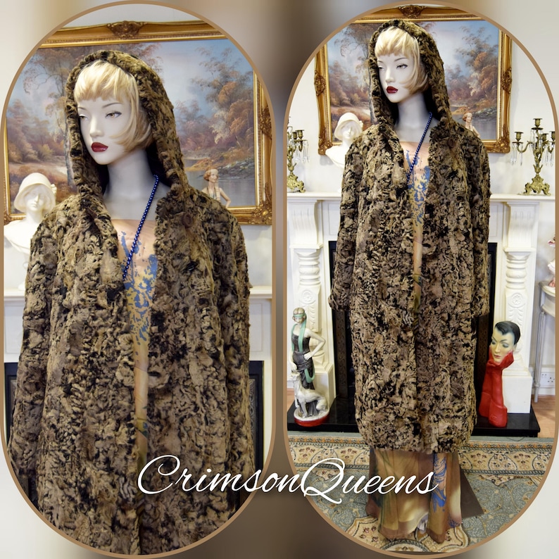 May include: A long, hooded coat with a textured, brown and black pattern. The coat is displayed on a mannequin with a blonde wig and red lipstick. The text "Crimson Queens" is visible at the bottom of the image. The coat appears to be vintage.