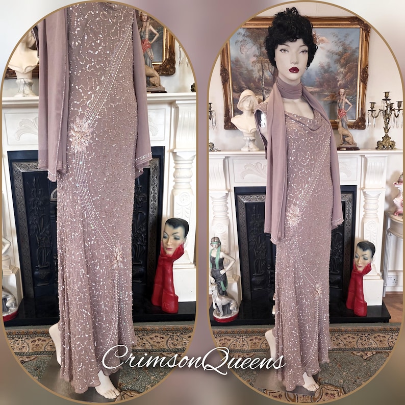 May include: A mauve evening gown, embellished with sequins and beads, displayed on a mannequin. The dress has a cowl neckline and is accompanied by a matching shawl. The image also shows the text "Crimson Queens".