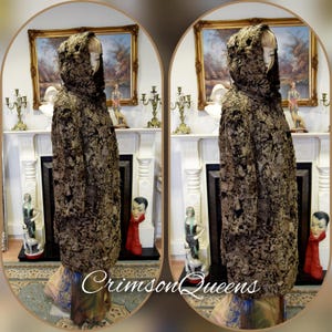 May include: A hooded coat with a textured, dark brown and black pattern. The coat is displayed on a mannequin. The text "Crimson Queens" is visible at the bottom of the image. The coat appears to be vintage or antique.