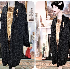 May include: A black long-sleeved jacket with a swirl pattern in silver sequins. The jacket has a shawl collar and a single button closure.