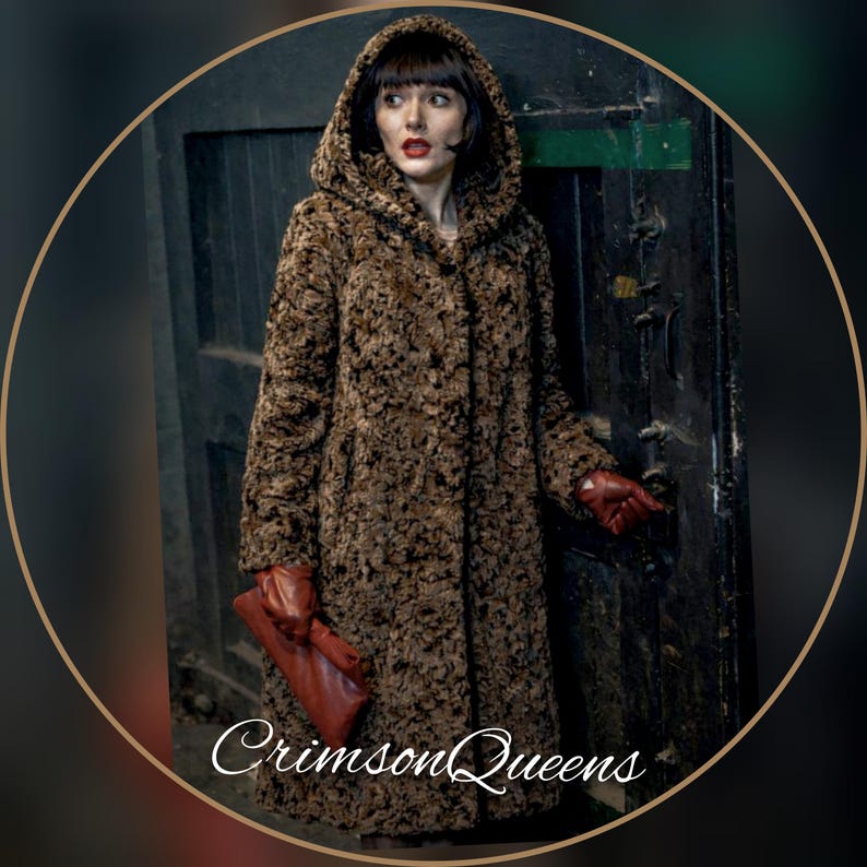 May include: A long, hooded brown coat with a textured pattern. The coat is buttoned up and worn with red gloves and a matching clutch. The text "Crimson Queens" is visible at the bottom.