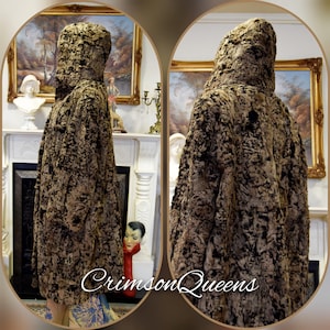 May include: A hooded coat with a textured, mottled pattern in shades of brown and black. The coat is displayed on a mannequin, showcasing its full length and design. The text "CrimsonQueens" is visible at the bottom of the image.
