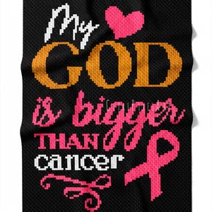 May include: Black blanket with the text "My God is bigger than cancer" in white, orange, and pink. A pink heart and a pink ribbon are also featured on the blanket. The blanket is made of a textured material.