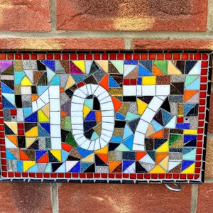 Custom mosaic door number plaques with all colours of the rainbow red