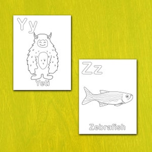 May include: Two white cards with black line drawings and text. One card features a Yeti with the letter "Yy" above and the word "Yeti" below. The other card shows a Zebrafish with the letter "Zz" above and the word "Zebrafish" below.