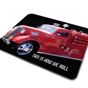 May include: A red vintage fire truck with a black background and the text "This is how we roll".