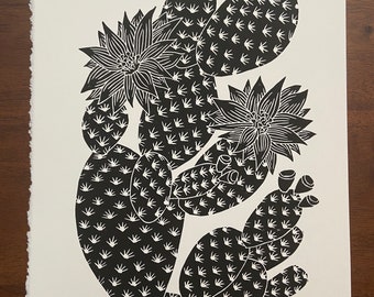 May include: Black and white print of a prickly pear cactus with flowers. The print is titled "Prickly Pear" and signed "B. Chilson '22". The print is numbered 1/40.