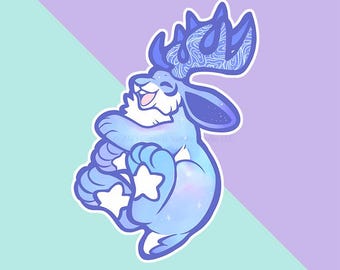 May include: A sticker featuring a blue jackalope with large antlers, a starry galaxy pattern on its body, and white star shapes on its feet. The creature has a joyful expression with its mouth open and eyes closed, set against a split background.