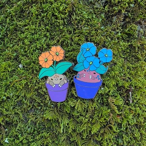 Broches de esmalte com botões de flores que brilham no escuro