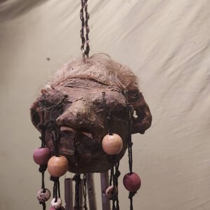 Beaded shrunken head wind chime