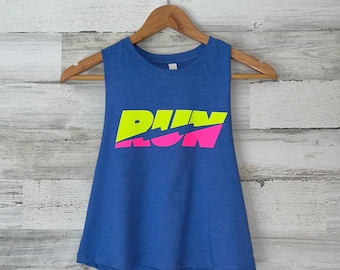 May include: A blue sleeveless crop top with the words "RUN" in pink and "WIN" in yellow.