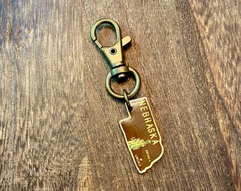 Ciondolo a forma di Stato del Nebraska, ciondolo vintage in smalto NE per borsa, amore per lo Stato, orgoglio per lo Stato, clip per zaino, borsa, cerniera, portachiavi, borsetta, distintivo, cordino