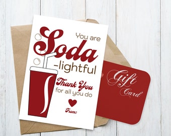 May include: Printable gift tag with a red soda can illustration and the text "You are Soda-lightful Thank You for all you do From:". The tag is on a brown envelope with a red gift card that says "Gift Card" in white.