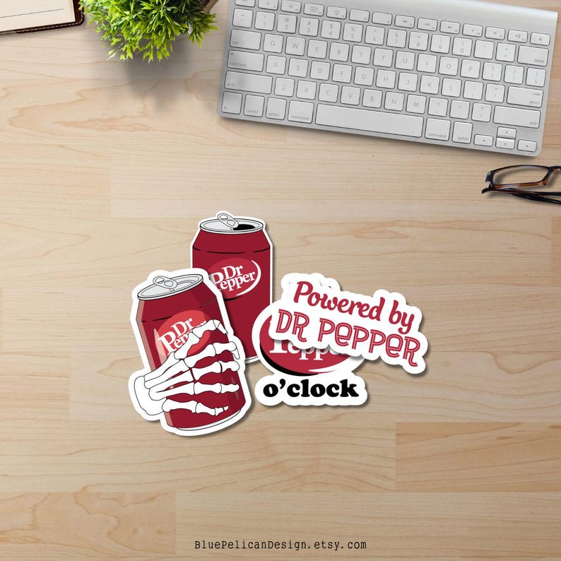 May include: Two red and white Dr Pepper cans with a skeleton hand holding one of the cans. The text "Powered by Dr Pepper o'clock" is in a white circle with a red outline.