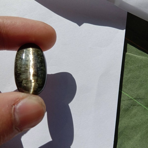 tourmaline catseye cabochon good catseye effect in all kinds of light hand polished piece weight 21.85cts size 28*15.50*5m.m.loose piece.