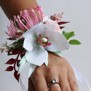White Orchid Wrist Corsage with Pink Thistle – Bridesmaid Bracelet for Tropical Wedding, Prom, or Photoshoot – Artificial Flowers