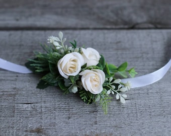 prom corsage with white ribbon and white spray roses with baby's breath