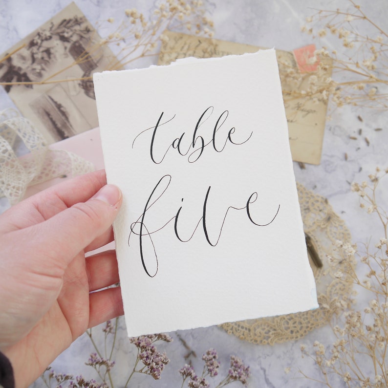 Table number sign in black calligraphy for weddings