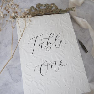 Textured Table Number Signs, Embossed Calligraphy Wedding Table Name Signage, Off White Event Table Decor, Ornate A6 Handwritten Custom Sign image 8