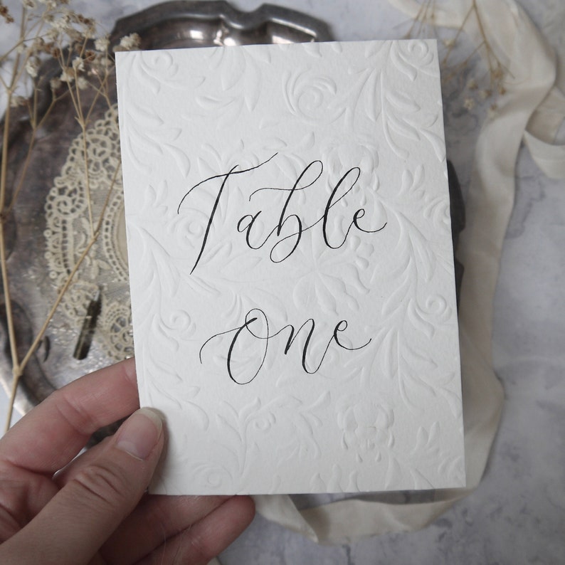Textured Table Number Signs, Embossed Calligraphy Wedding Table Name Signage, Off White Event Table Decor, Ornate A6 Handwritten Custom Sign image 3