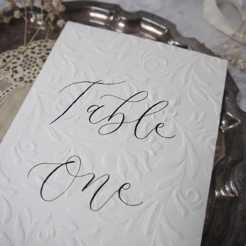 Wedding table number sign with calligraphy writing