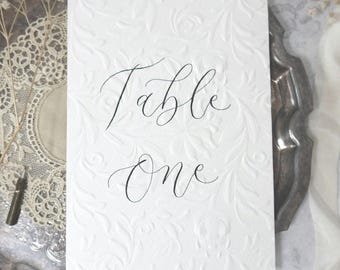Embossed Floral Wedding Table Numbers: Handmade Calligraphy A6 Sign