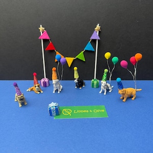 May include: A white ceramic mug with a black handle and the text "But First, Coffee" in a handwritten style. The mug is on a white surface. The mug is 10 cm tall.