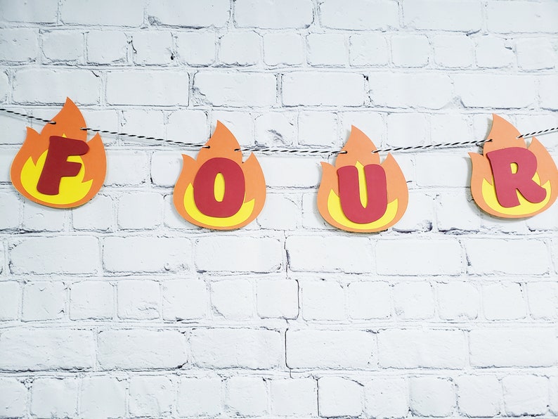 May include: A red and yellow paper banner with the word "FOUR" in red letters. The banner is shaped like flames.