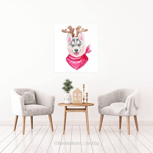 May include: Watercolor painting of a husky dog wearing a red bandana and reindeer antlers. The dog is looking at the viewer with a happy expression.
