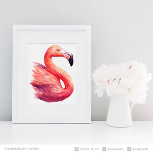 May include: A watercolor painting of a pink flamingo with a white background. The flamingo is facing to the right and its head is turned to the left. The painting is framed in a white frame.