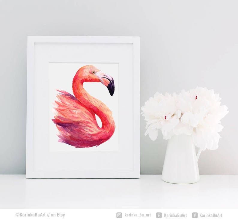 May include: A watercolor painting of a pink flamingo with a white background. The flamingo is facing to the right and its head is turned to the left. The painting is framed in a white frame.