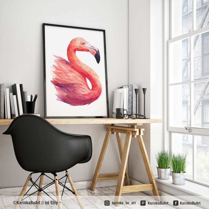 May include: A watercolor painting of a pink flamingo with its head turned to the side. The flamingo is painted in a realistic style with detailed feathers and a long, slender neck. The painting is framed in a black frame and is hanging on a white wall.