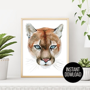 May include: A watercolor painting of a cougar's face with blue eyes. The cougar is looking directly at the viewer. The background is white.