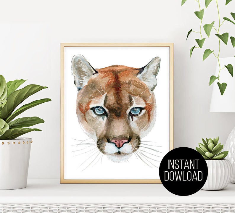 May include: A watercolor painting of a cougar's face with blue eyes. The cougar is looking directly at the viewer. The background is white.