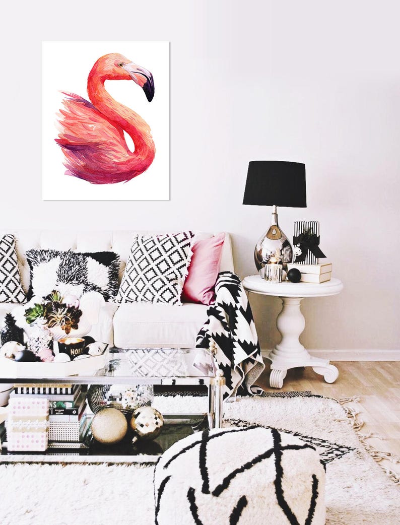 May include: A watercolor painting of a pink flamingo with a white background. The flamingo is in a standing position with its head turned to the side. The painting is framed and hanging on a white wall.