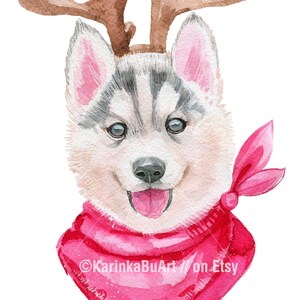 May include: Watercolor painting of a husky puppy wearing a pink bandana and reindeer antlers. The puppy has blue eyes and is looking directly at the viewer. The text "KarinkaBuArt // on Etsy" is at the bottom of the image.