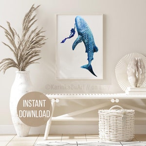 May include: A watercolor painting of a whale shark swimming with a diver. The whale shark is blue and white with black spots. The diver is wearing a purple wetsuit and is holding onto the whale shark's fin. The painting is framed in a white frame and is hanging on a white wall.