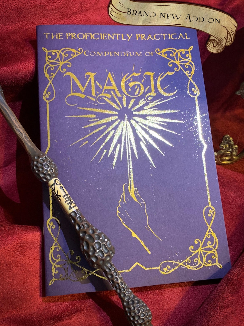 Deep purple book titled The Proficiently Practical Compendium of Magic with golden designs laid on a rich red fabric backdrop A detailed ornate wand rests diagonally atop the book. Above, a banner reads Brand new Add on. Ideal for magical enthusiasts