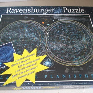 May include: A Ravensburger 1000-piece Star Line jigsaw puzzle box featuring a celestial planisphere map of the night sky. The dark blue box displays a detailed star chart, a glowing effect graphic, and the text Celestial Planisphere.