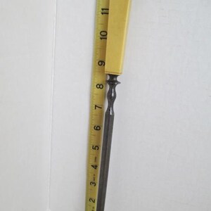 Pu&ograve; includere: Una lima di metallo vintage con un manico in osso. La lima &egrave; lunga circa 25 cm e ha una punta arrotondata. Il manico &egrave; di colore giallo pallido.