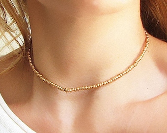 Collana girocollo con perline dorate e collana in vetro per donna