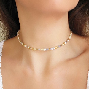 Mix gold seed bead choker necklace made of 2.9mm glass seed beads. Length is 13 inches or 15 inches plus 2 inches extender chain. Closes with stainless steel lobster clasp.