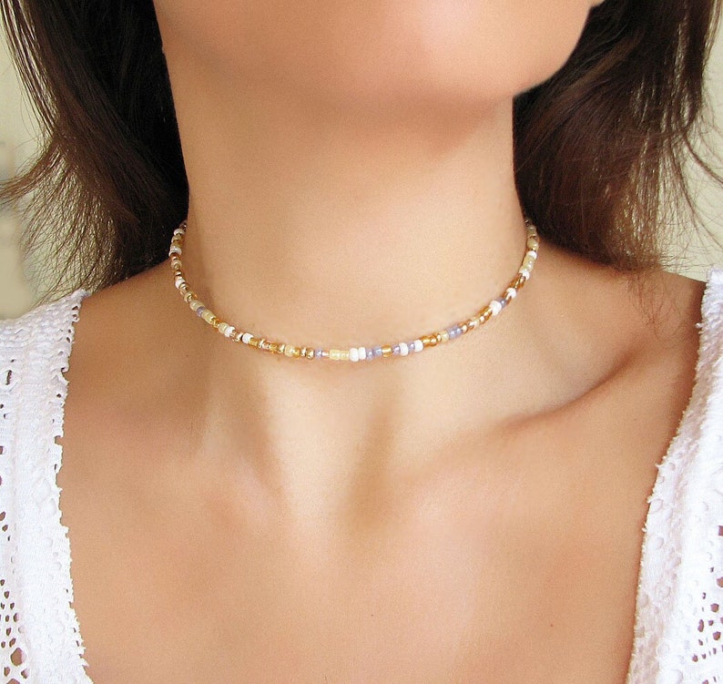 Mix gold seed bead choker necklace made of 2.9mm glass seed beads. Length is 13 inches or 15 inches plus 2 inches extender chain. Closes with stainless steel lobster clasp.