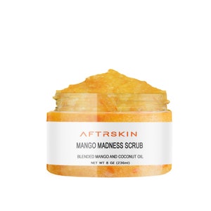 May include: A clear jar with a yellow mango and coconut oil body scrub. The label reads "AFTRSKIN MANGO MADNESS SCRUB BLENDED MANGO AND COCONUT OIL NET WT 8 OZ (236ml)"